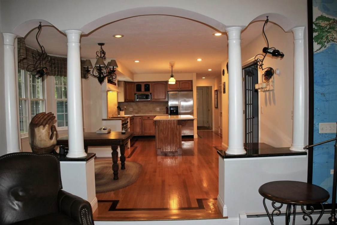An open kitchen with freshly painted cabinetry by Brookstone Painting and Carpentry