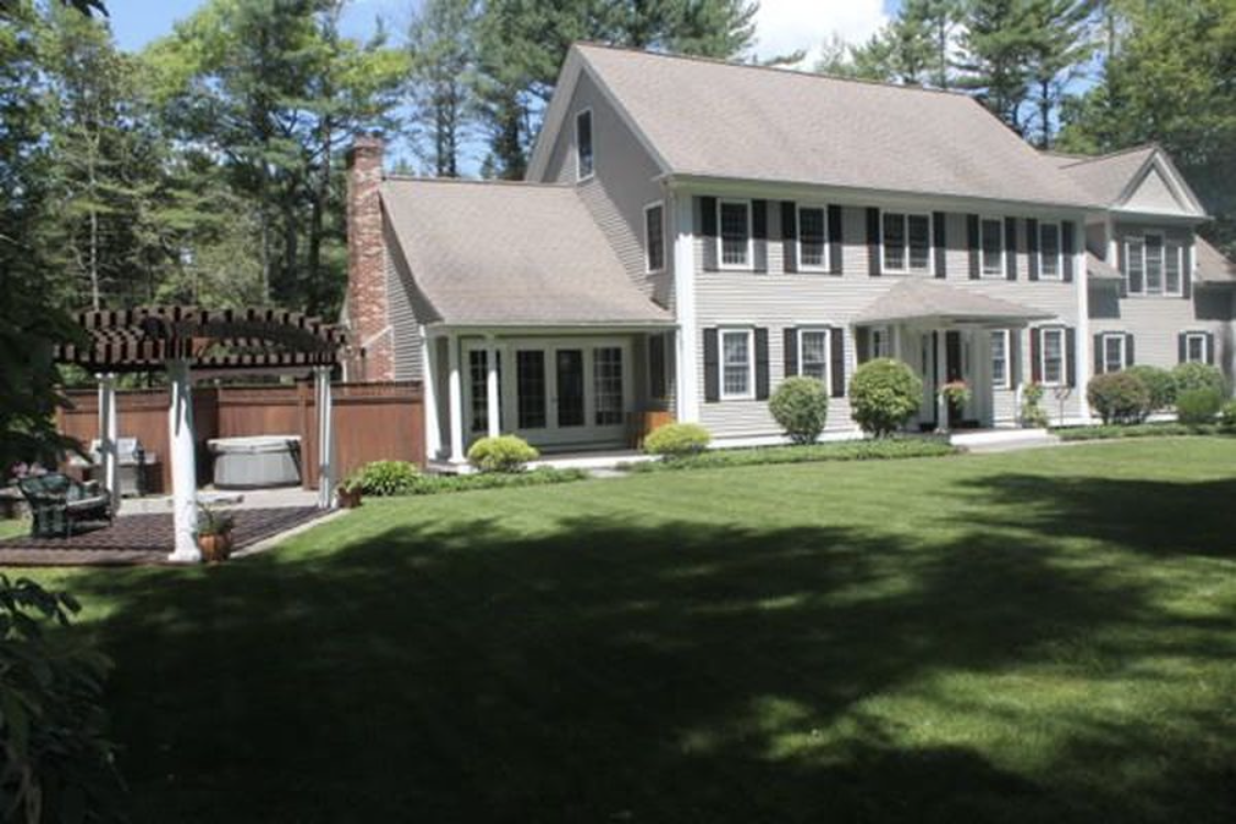 Exterior painting of a gray colonial home after a full repaint by Brookstone Painting and Carpentry in Plymouth County