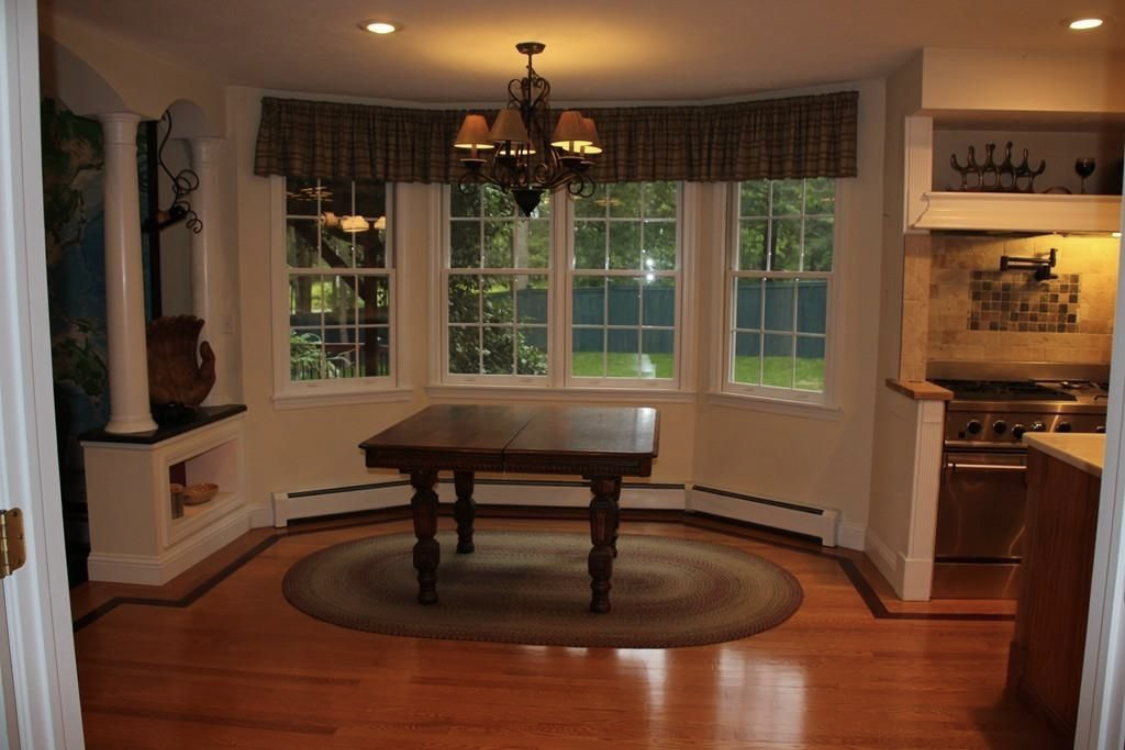 A dining nook with a bay window painted by Brookstone Painting and Carpentry in Plymouth County and Cape Cod