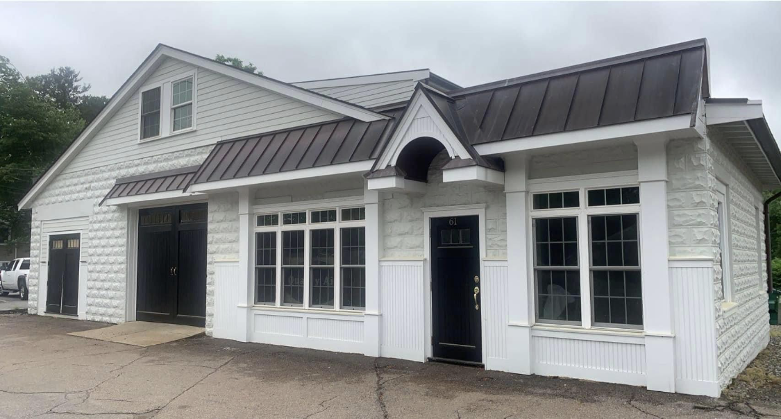 A white home with crisp black roof and trim painted by Brookstone Painting and Carpentry in Plymouth County and Cape Cod