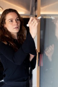 Forretningsrådgiver skriver på tavle. Foto.