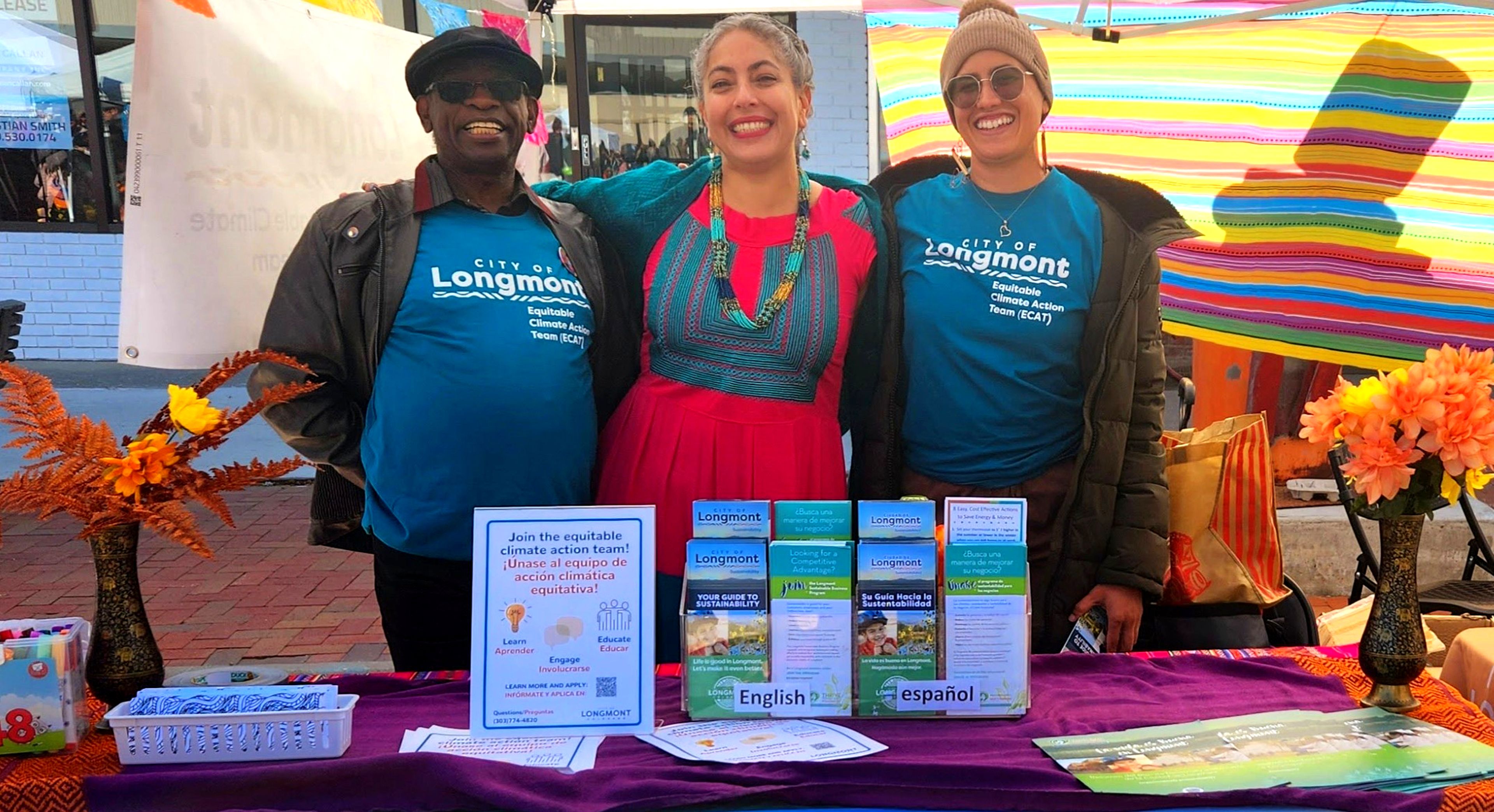 Equitable Climate Action Team members Osvaldo Jane Gomez and Erica Lee standing next to Sustainability Coordinator Laura Soto while tabling at a community event
