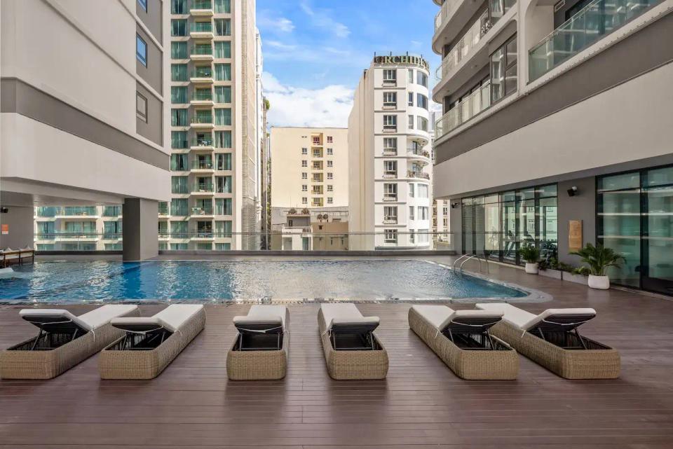 Aether Apartments pool deck with sunbeds