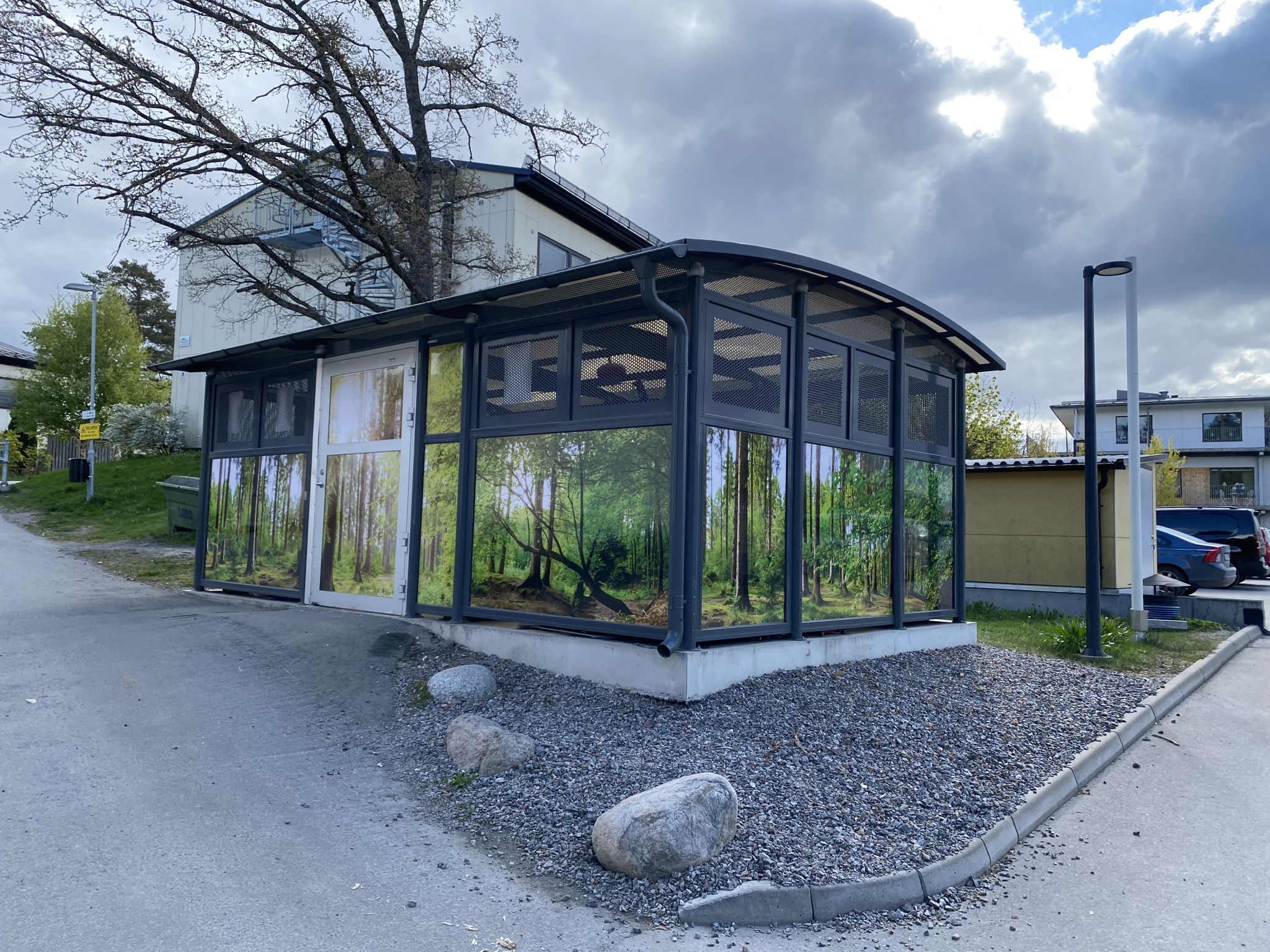 visar miljöhuset som har tapetserats på utsidan med tapet som visar träd och skog. 