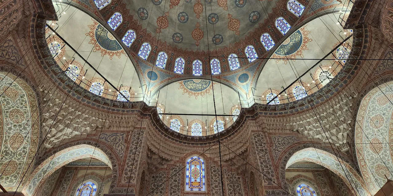 Intricate tilework and soaring domes inside the Blue Mosque, Istanbul, Turkey