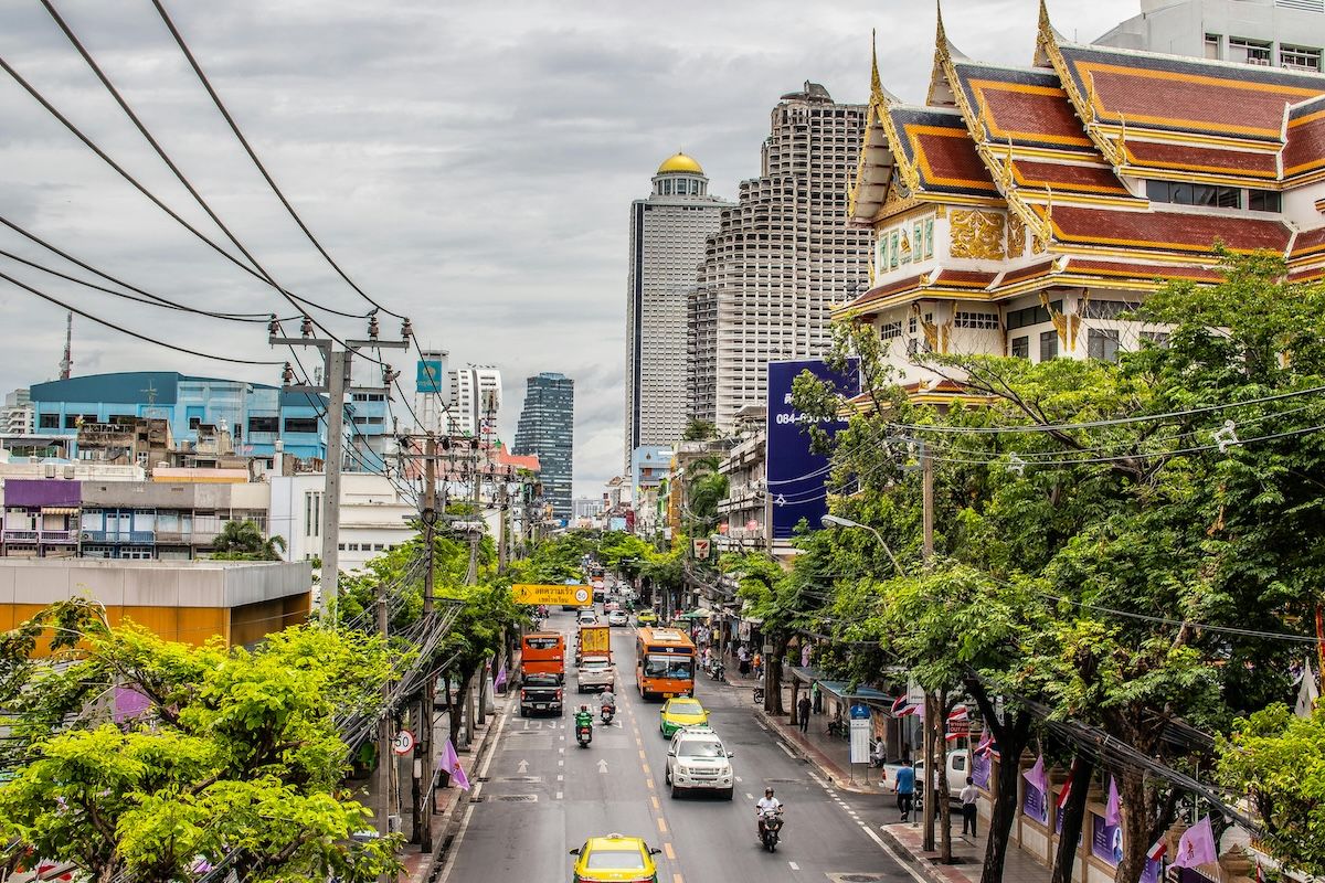 A vibrant night view of Bangkok's illuminated skyline featuring modern skyscrapers.
