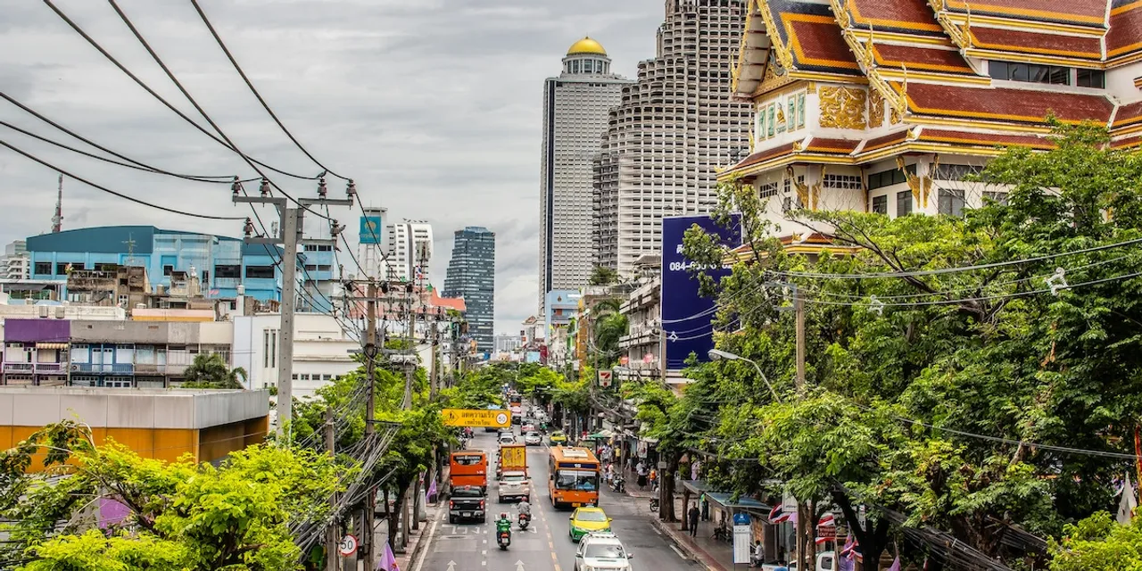 A vibrant night view of Bangkok's illuminated skyline featuring modern skyscrapers.