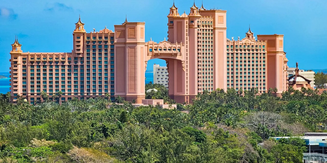 A stunning view of the iconic Atlantis Resort in Nassau, Bahamas, surrounded by lush greenery.
