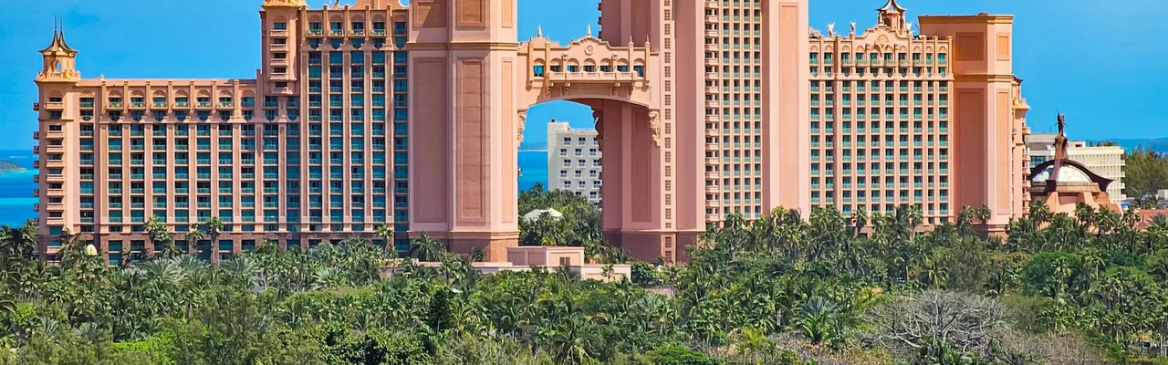 A stunning view of the iconic Atlantis Resort in Nassau, Bahamas, surrounded by lush greenery.
