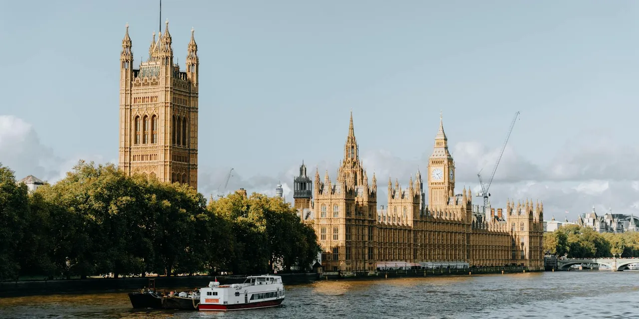 View of the iconic Houses of Parliament and Big Ben along the River Thames in central London.