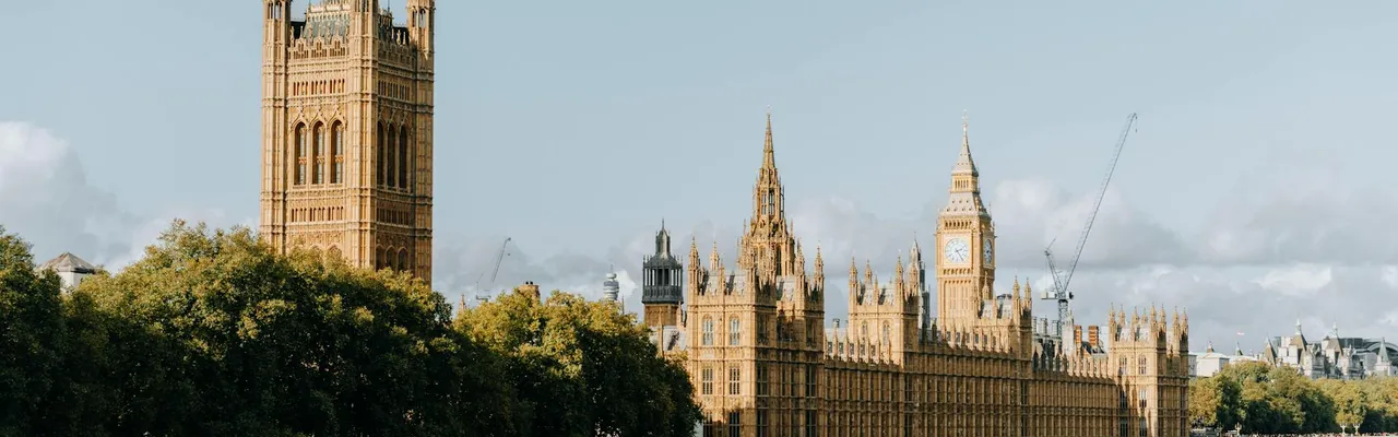 View of the iconic Houses of Parliament and Big Ben along the River Thames in central London.