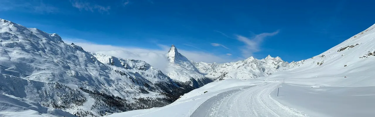 A breathtaking view of the Matterhorn amidst snowy mountains in Zermatt, Switzerland.