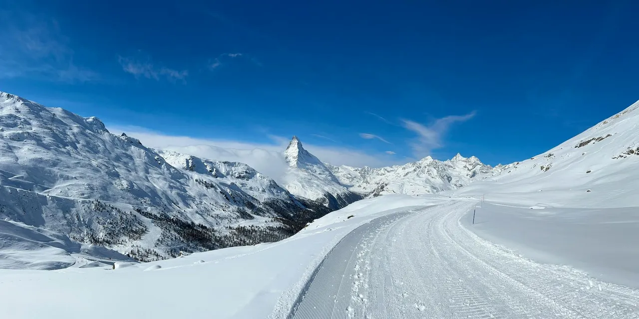 A breathtaking view of the Matterhorn amidst snowy mountains in Zermatt, Switzerland.
