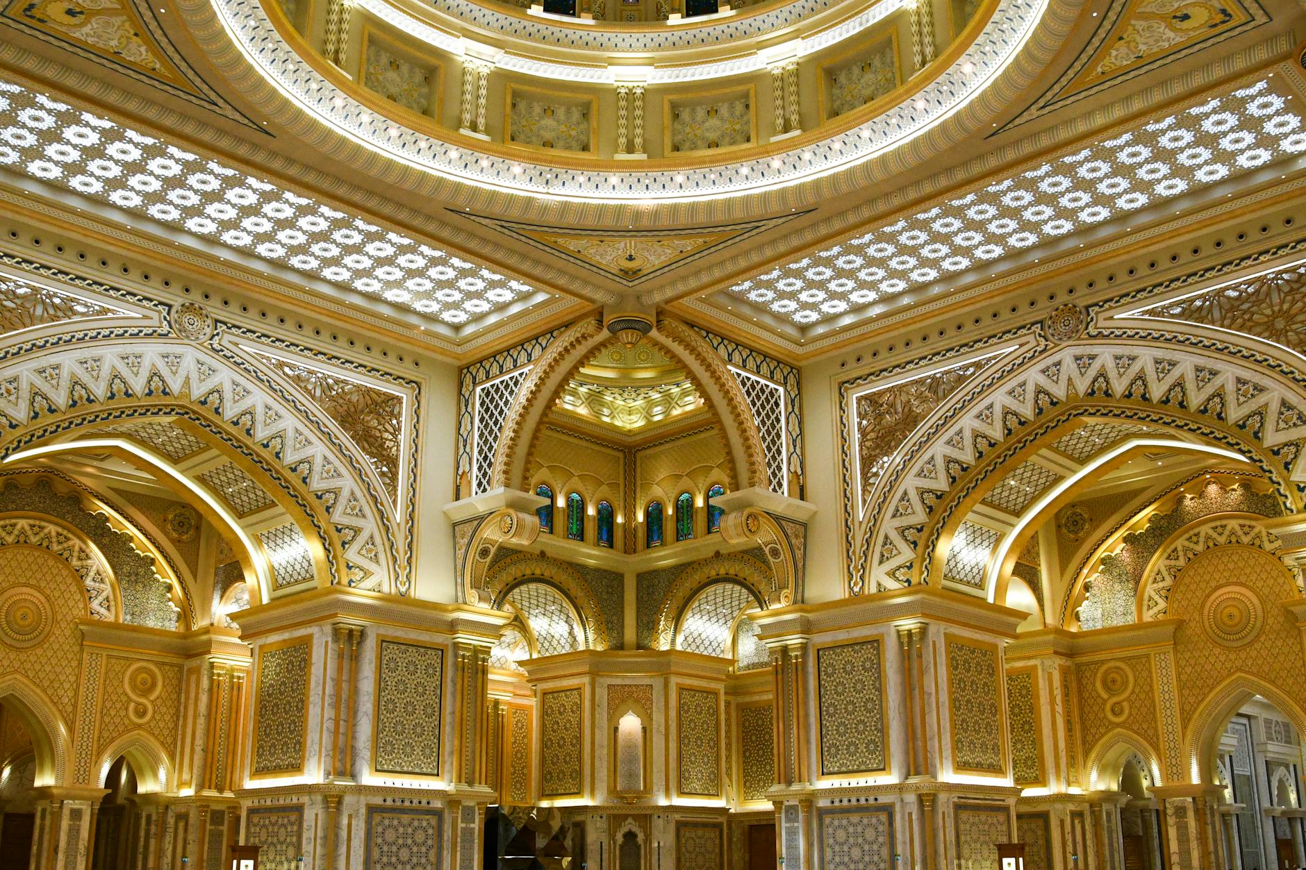 Stunning ornate interior of a palace in Abu Dhabi, showcasing intricate Islamic architecture.