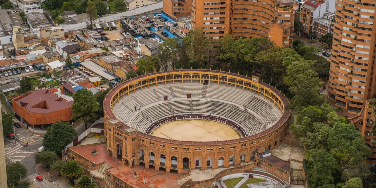 Drone view of the iconic Santamaria Bullring surrounded by urban Bogotá, Colombia.