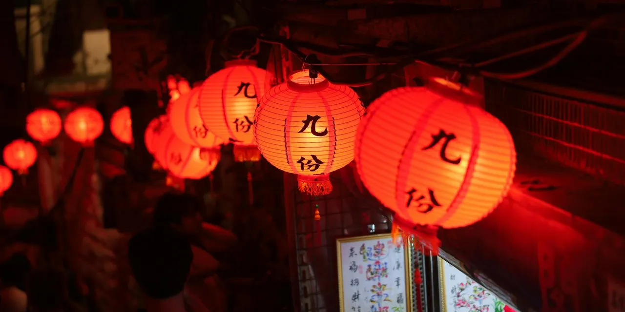 Enchanting night scene with red lanterns illuminating Jiufen Market, Taiwan.