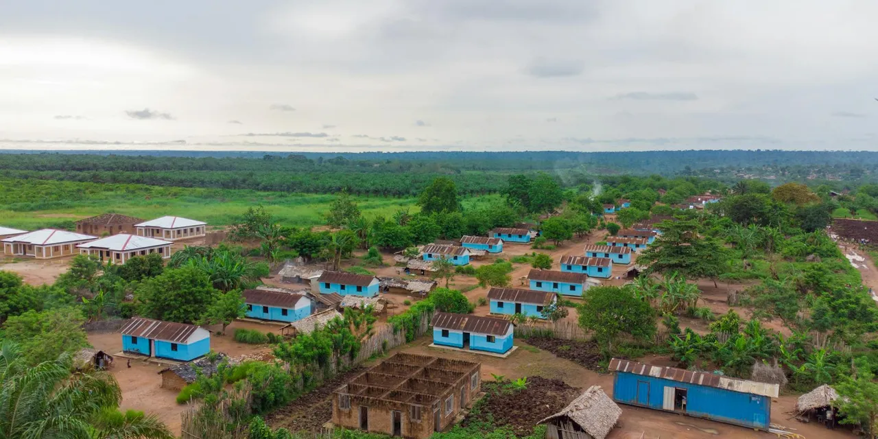 Aerial shot capturing the rural village landscape in DR Congo's lush green environment.
