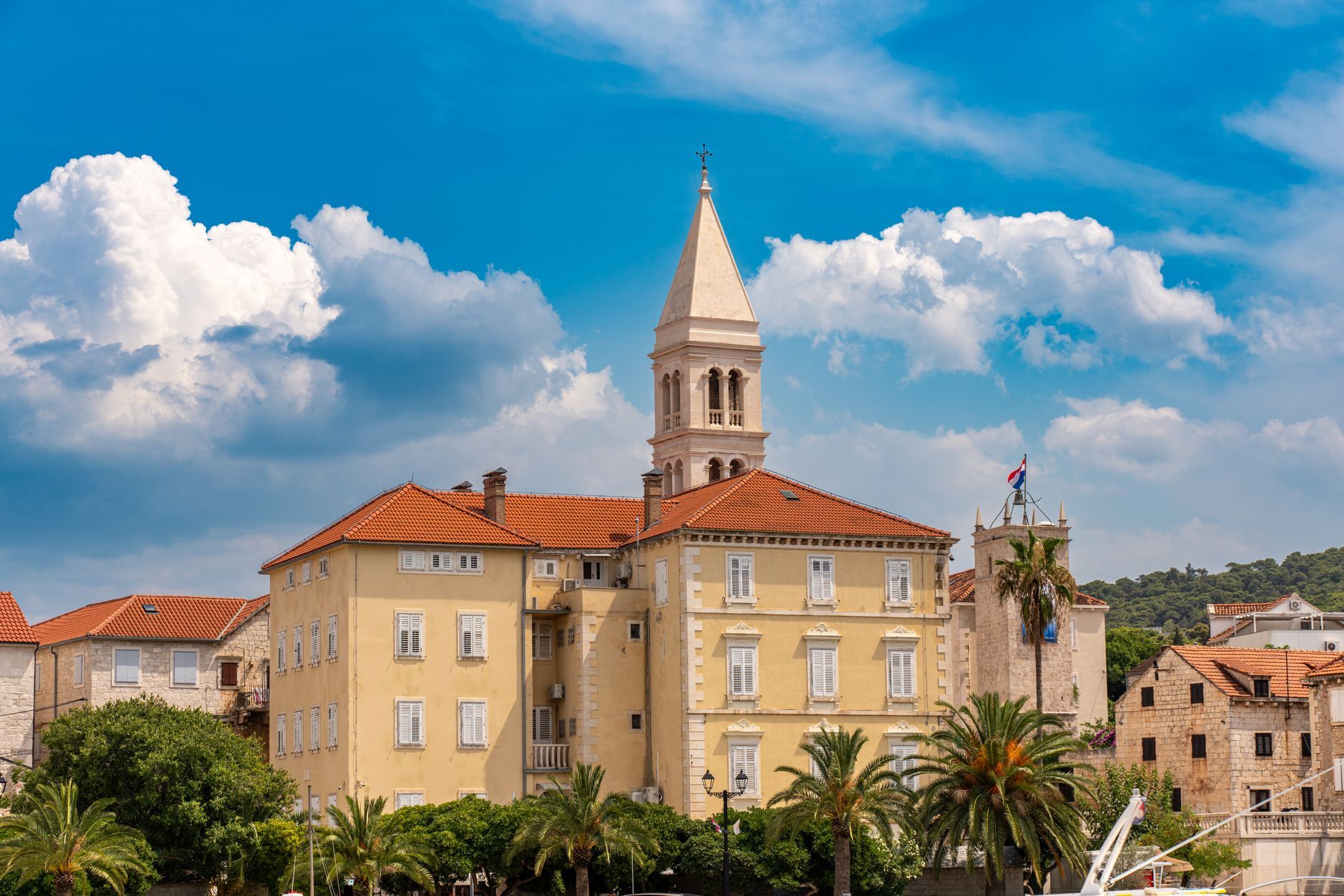 Picturesque view of historic architecture in Supetar, Croatia, under a clear blue sky.