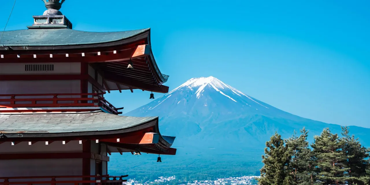 Scenic view of Chureito Pagoda with Mount Fuji in the background under a clear blue sky.