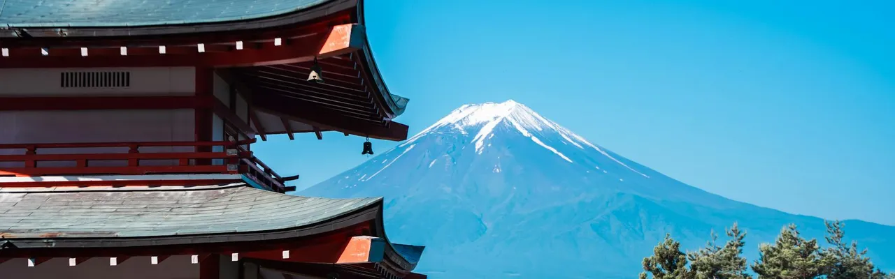 Scenic view of Chureito Pagoda with Mount Fuji in the background under a clear blue sky.