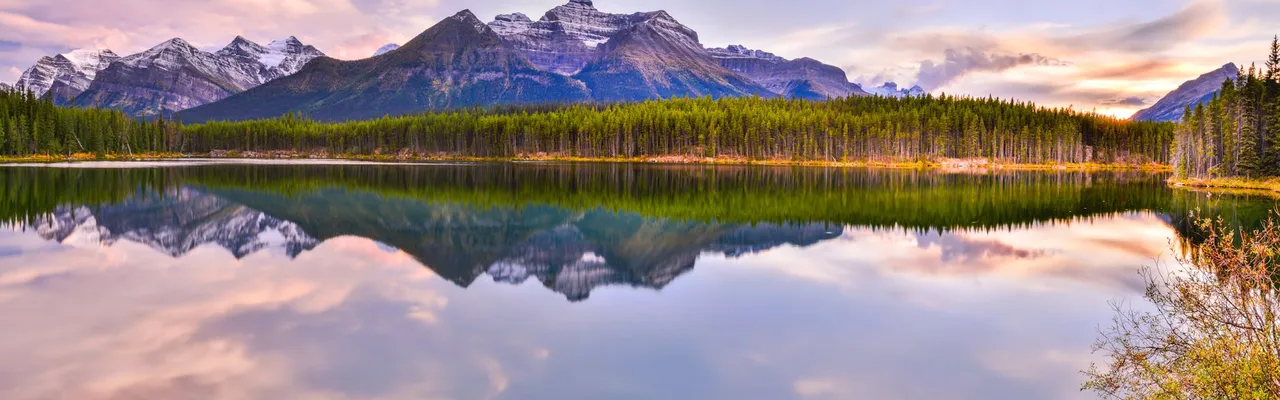 Beautiful reflection of mountains on Herbert Lake during sunset in Banff National Park, Canada.