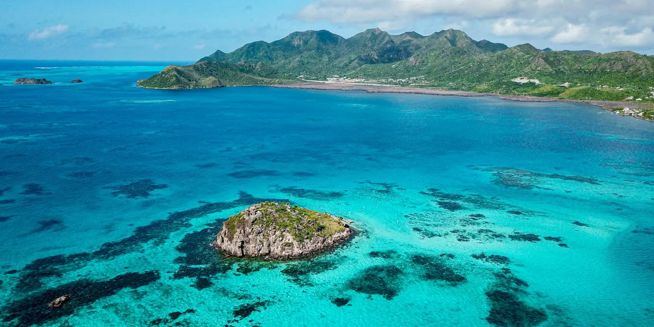 Breathtaking aerial shot of Providencia Island's clear turquoise waters and rugged coastline.