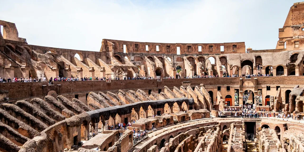 Explore the ancient architecture of the Roman Colosseum's interior, showcasing its historic beauty.