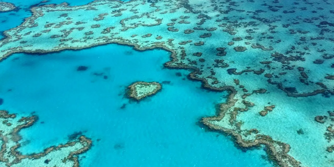 Stunning aerial photograph of the heart-shaped Great Barrier Reef in the Whitsundays, Australia.