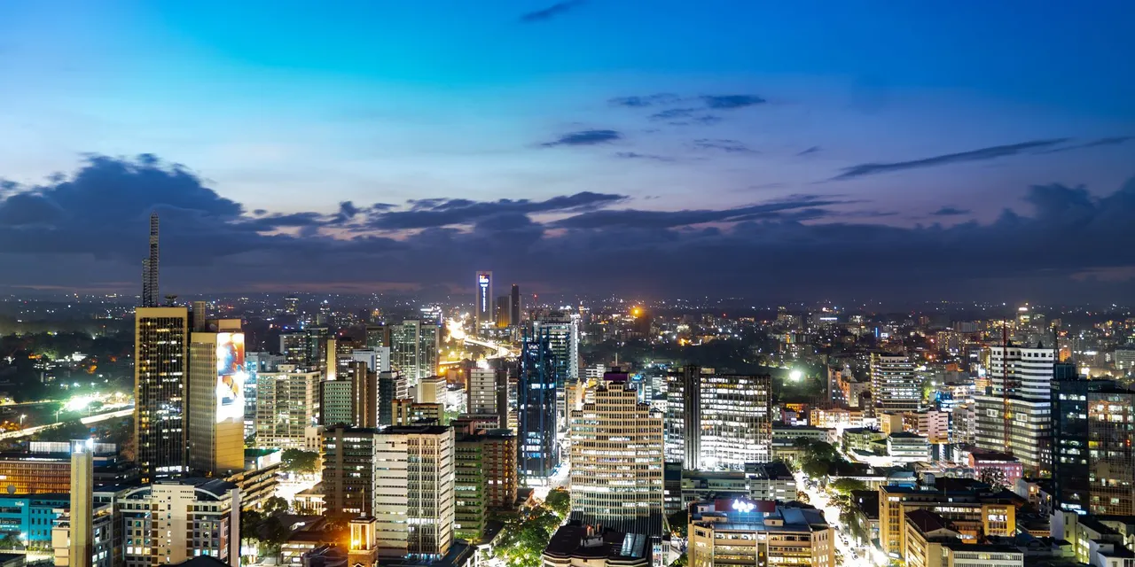 Breathtaking view of Nairobi's skyline during twilight, showcasing vibrant city lights.