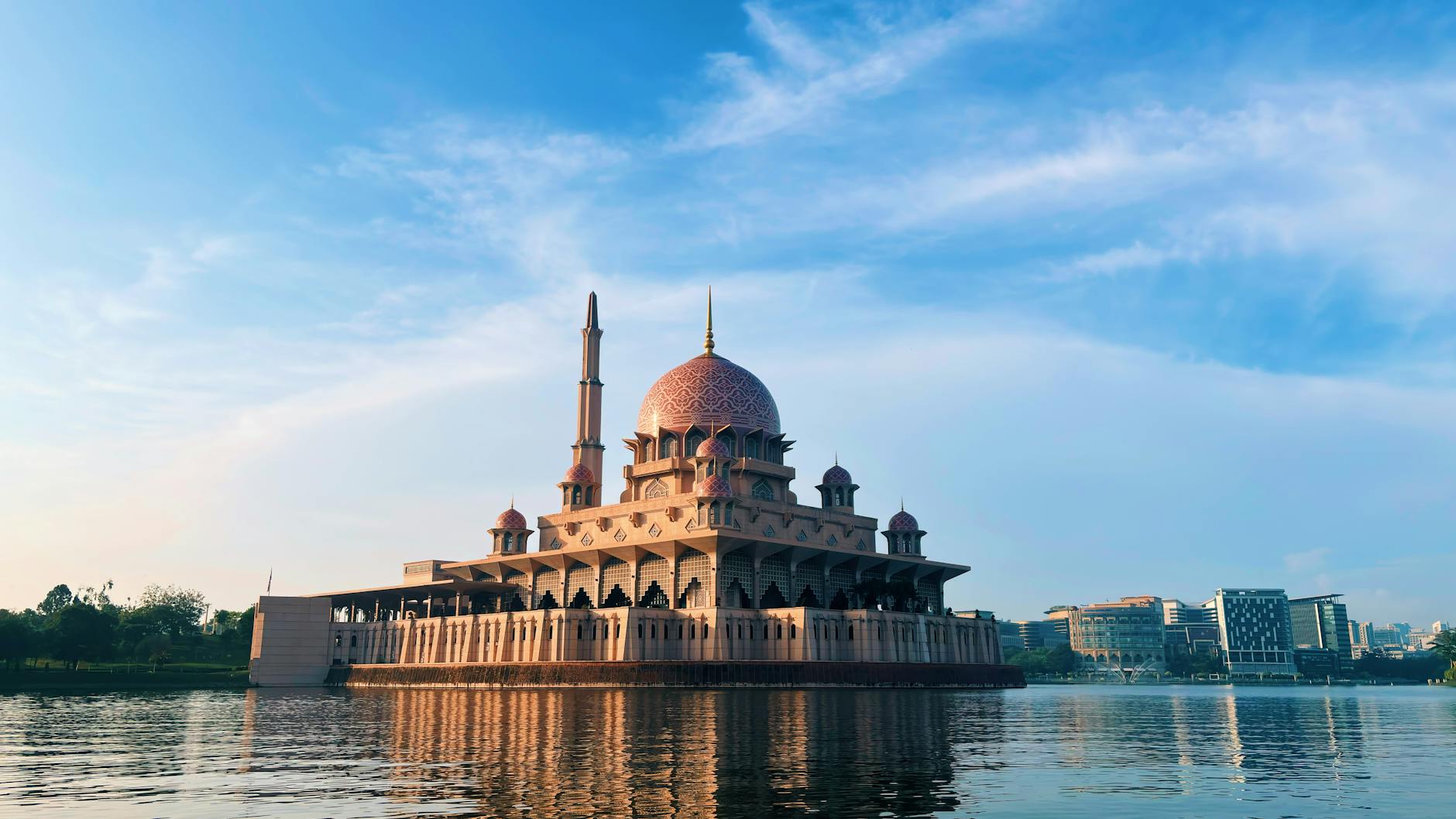 Scenic view of the majestic Putra Mosque in Putrajaya against a clear blue sky.