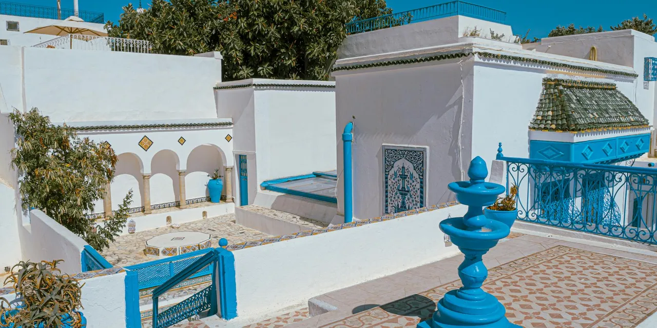 Vibrant Mediterranean-style architecture featuring blue and white hues in Carthage, Tunisia.