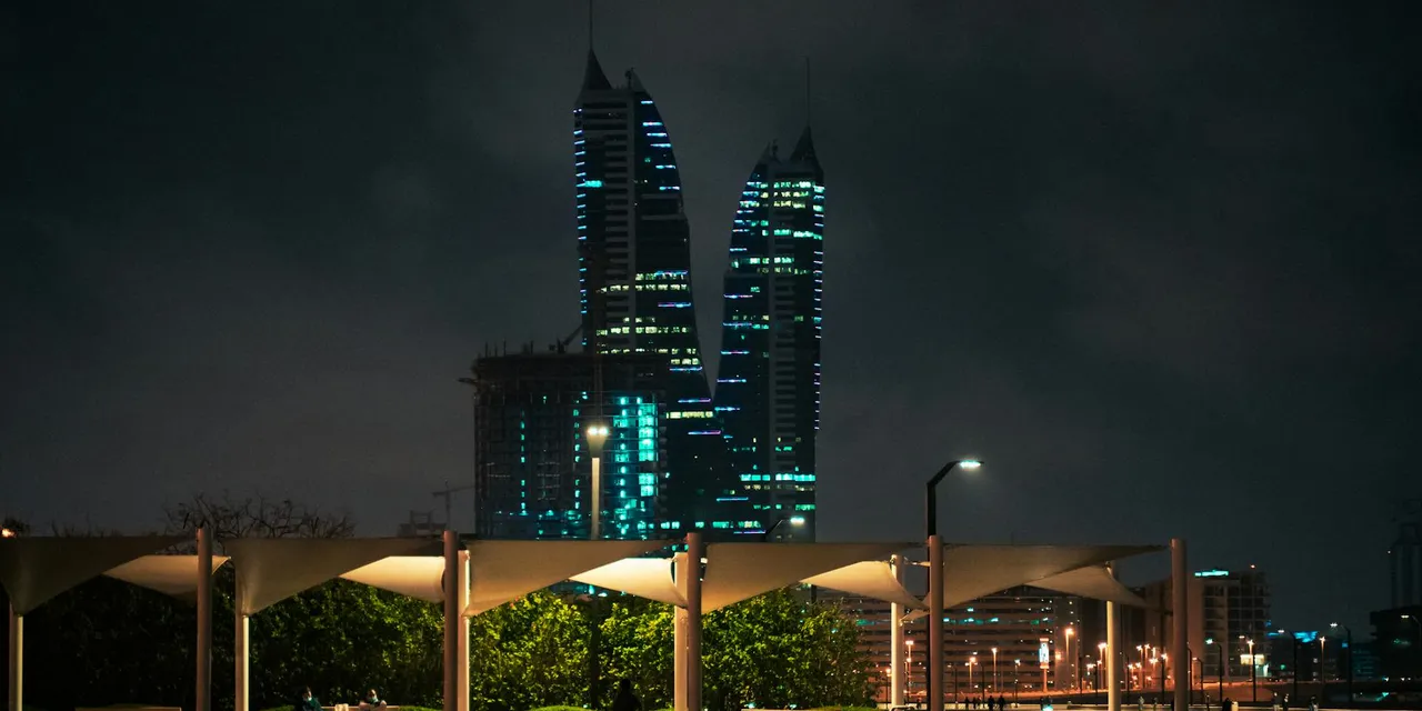 Stunning night view of Bahrain's skyline with illuminated modern towers and cityscape.