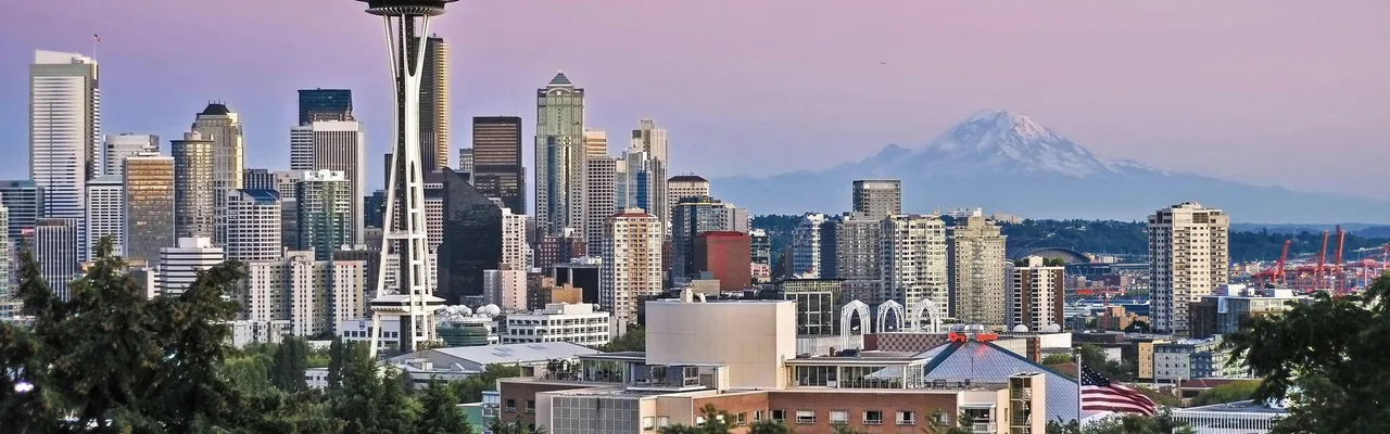 Seattle skyline with the Space Needle and Mount Rainier at sunset, United States