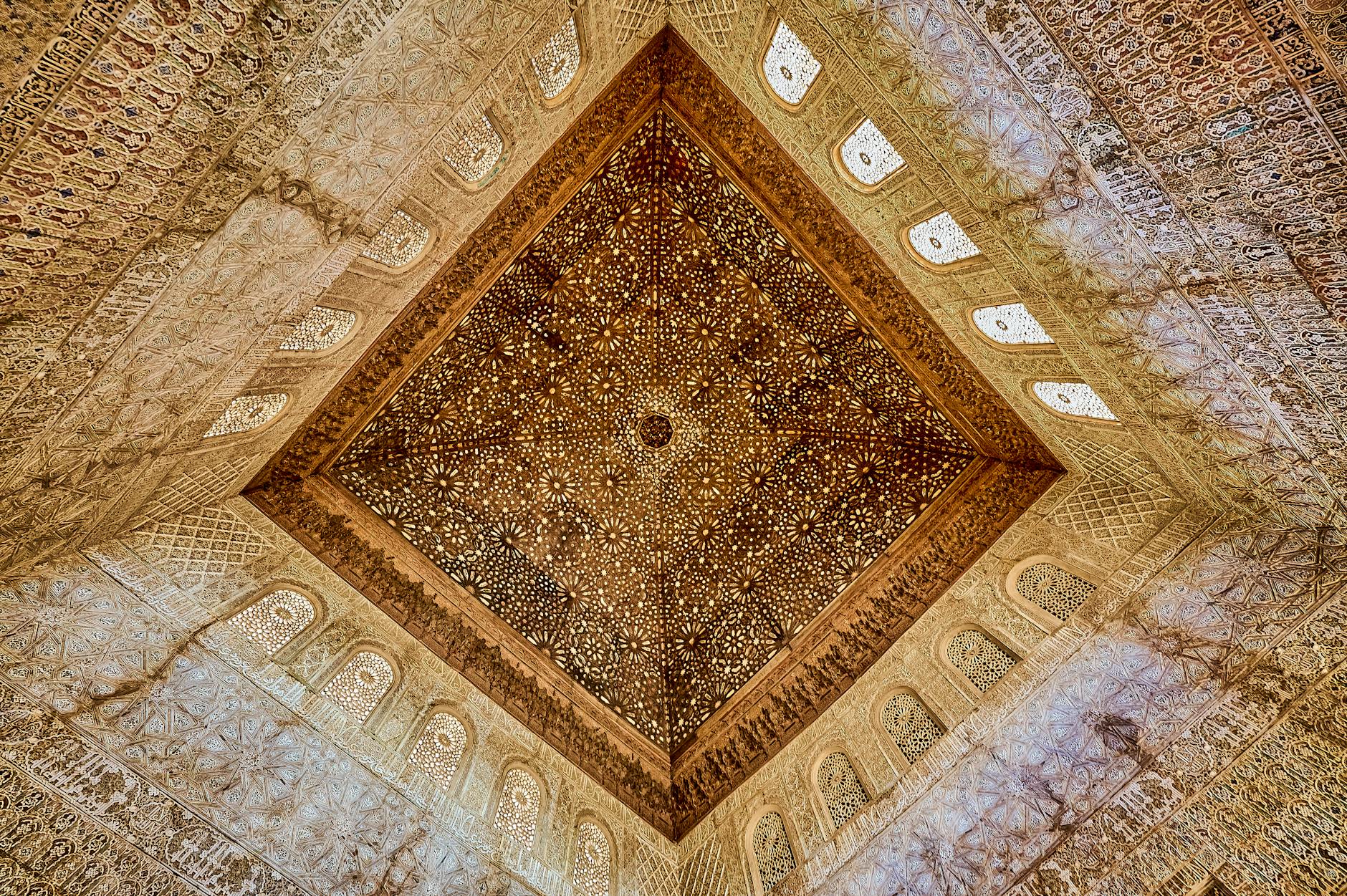 Intricately carved ceiling at Alhambra, showcasing Moorish design in Andalusia, Spain.