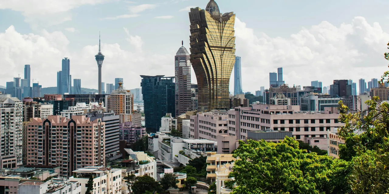 Macau skyline with the Grand Lisboa casino tower and Macau Tower rising above the city