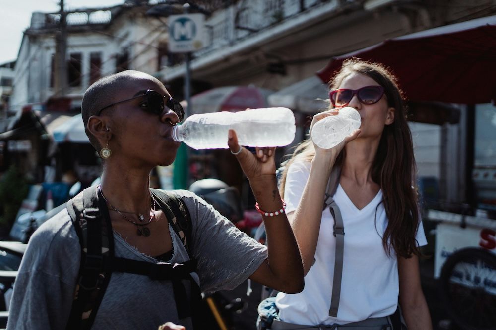 Female travellers with diabetes drinking bottled water in Mexico to stay hydrated