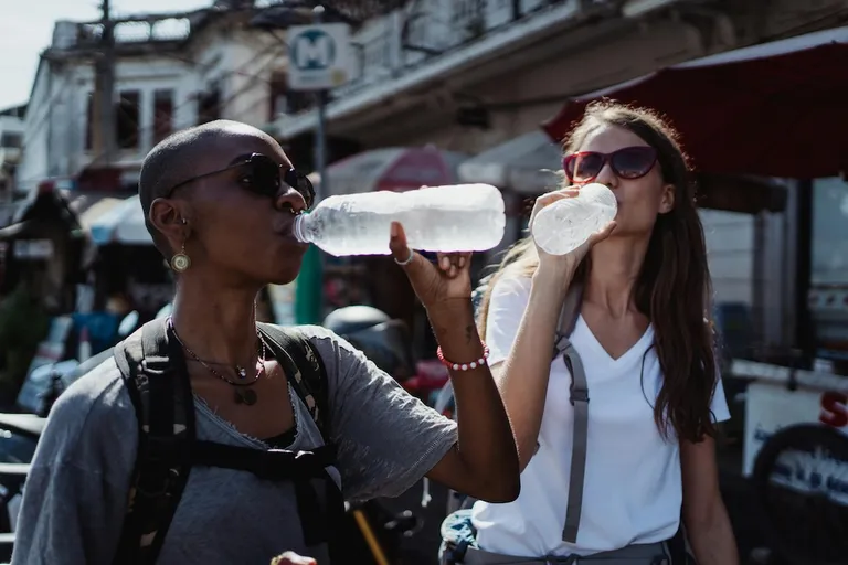 Female travellers with diabetes drinking bottled water in Mexico to stay hydrated