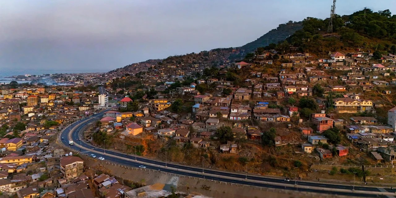 Aerial view of Freetown spreading across the hillside at dusk, Sierra Leone