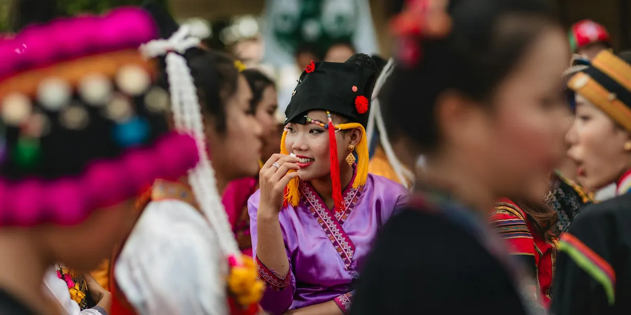 Colorful festivities at an Asian festival in Vientiane, Laos, showcasing traditional attire and cultural gathering.