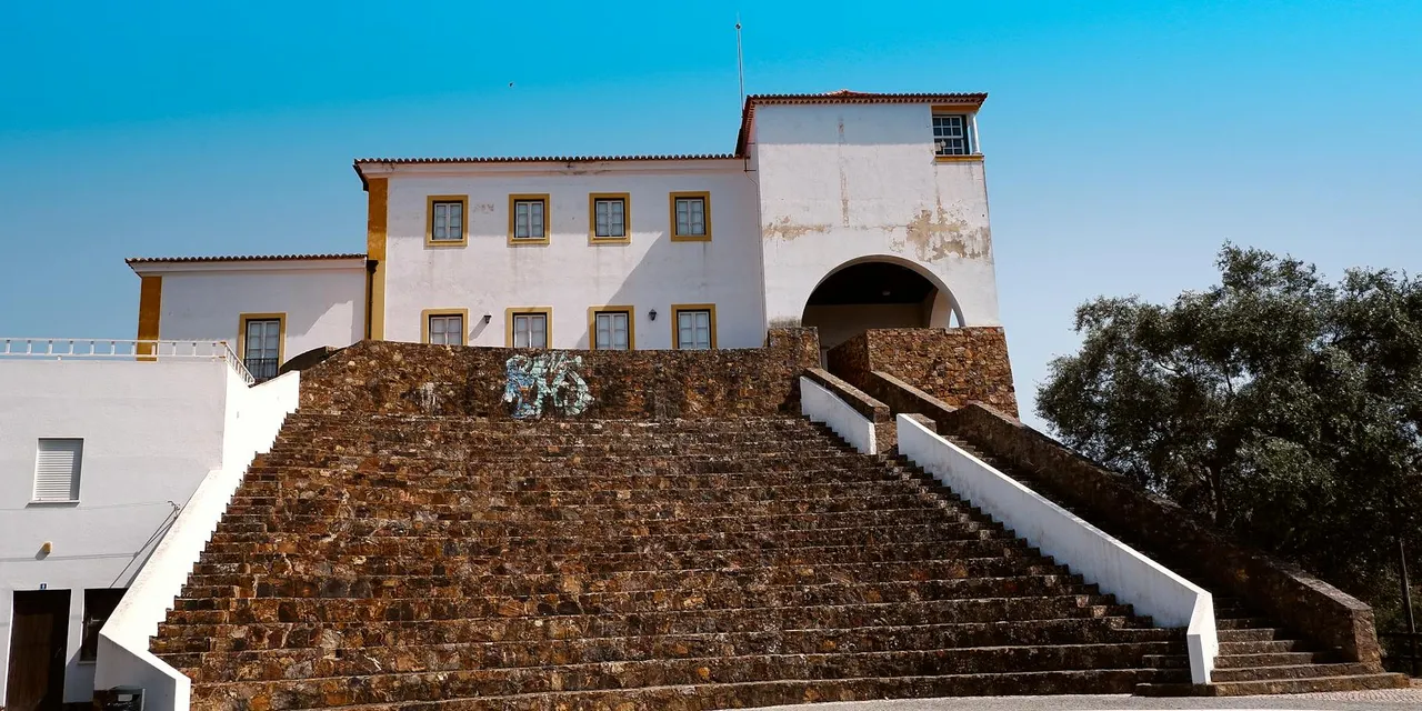 Elevated view of traditional Portuguese architecture in Odemira, Portugal under a clear blue sky.