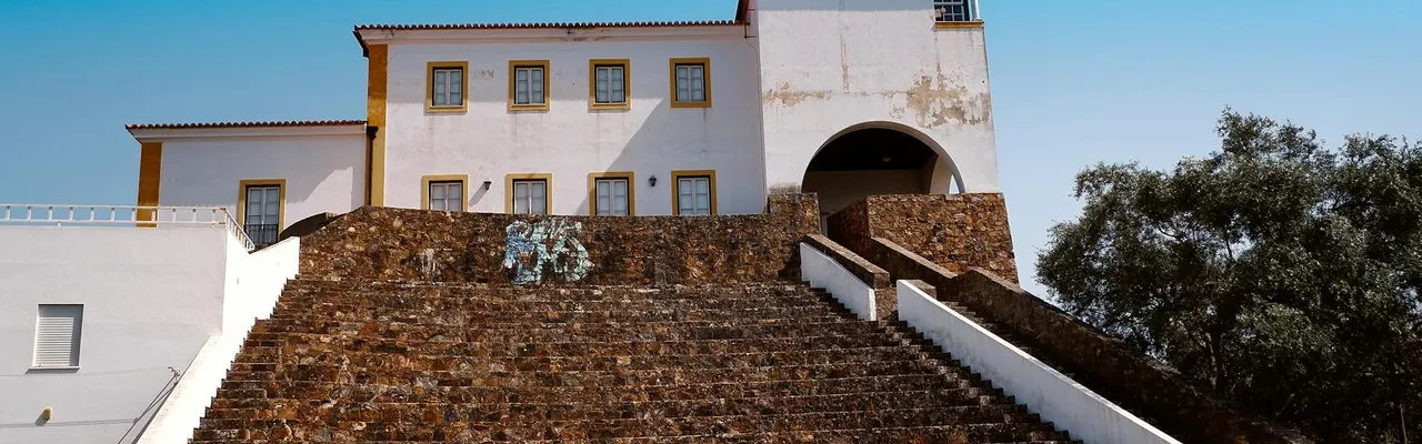 Elevated view of traditional Portuguese architecture in Odemira, Portugal under a clear blue sky.