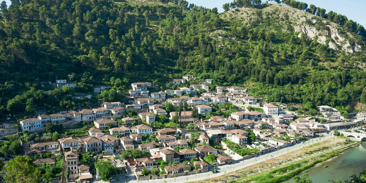 Explore the picturesque hillside town of Berat in Albania, showcasing its unique architecture.