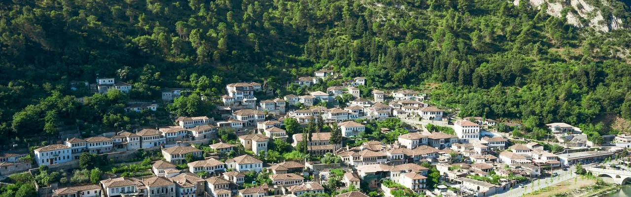 Explore the picturesque hillside town of Berat in Albania, showcasing its unique architecture.