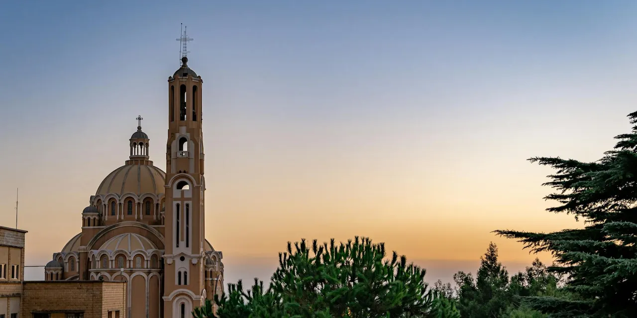 Captivating view of St Paul Basilica in Harissa, Lebanon during sunset with clear skies.