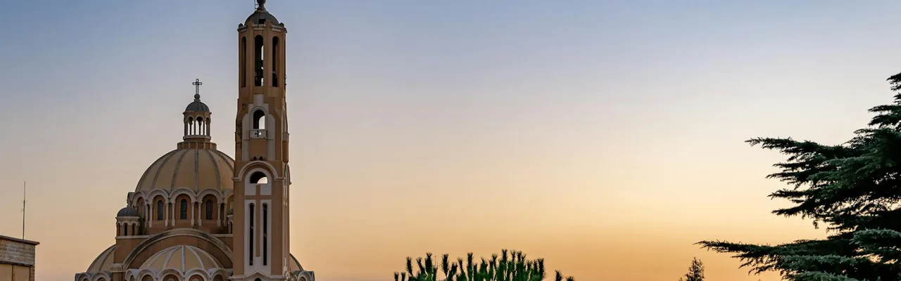 Captivating view of St Paul Basilica in Harissa, Lebanon during sunset with clear skies.