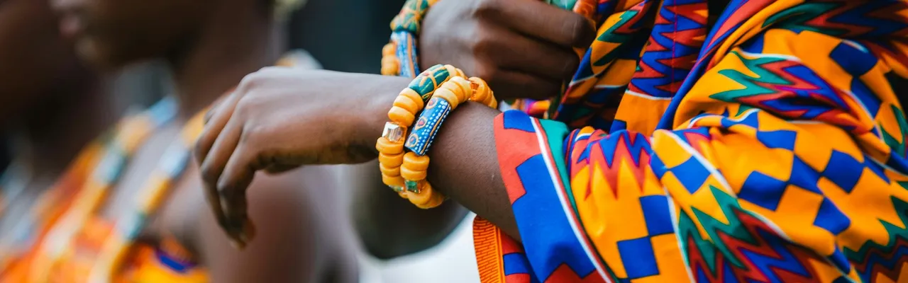 Ghanaian women in vibrant kente cloth at a cultural celebration, Ghana