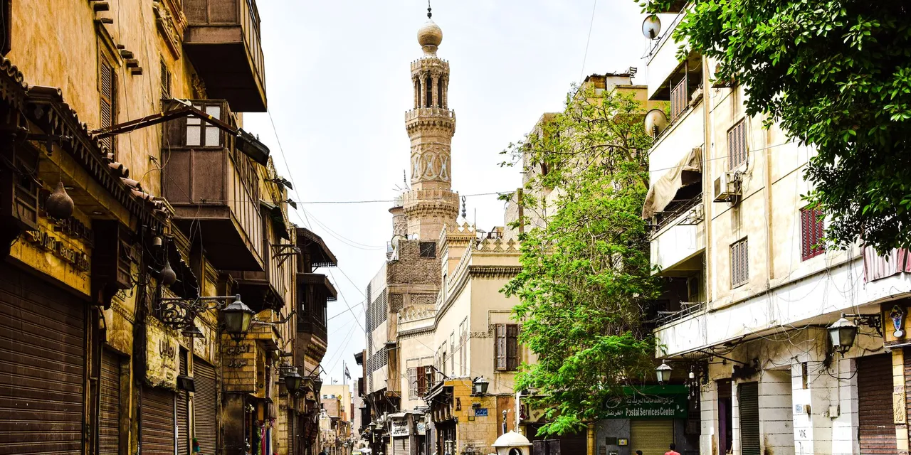 Explore the charm of a bustling historic street in Cairo with stunning architecture and cultural vibrancy.