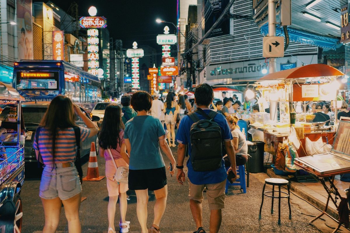Digital nomads in busy, stimulating street scene in Bangkok, Thailand