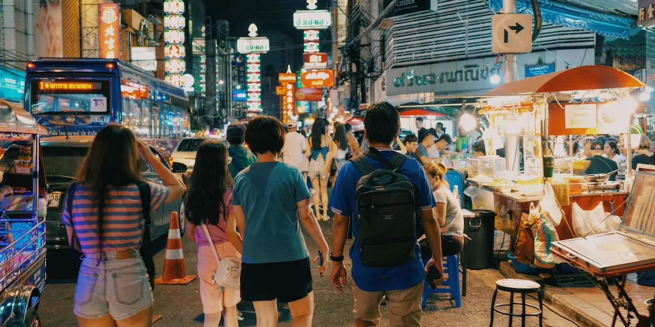 Digital nomads in busy, stimulating street scene in Bangkok, Thailand