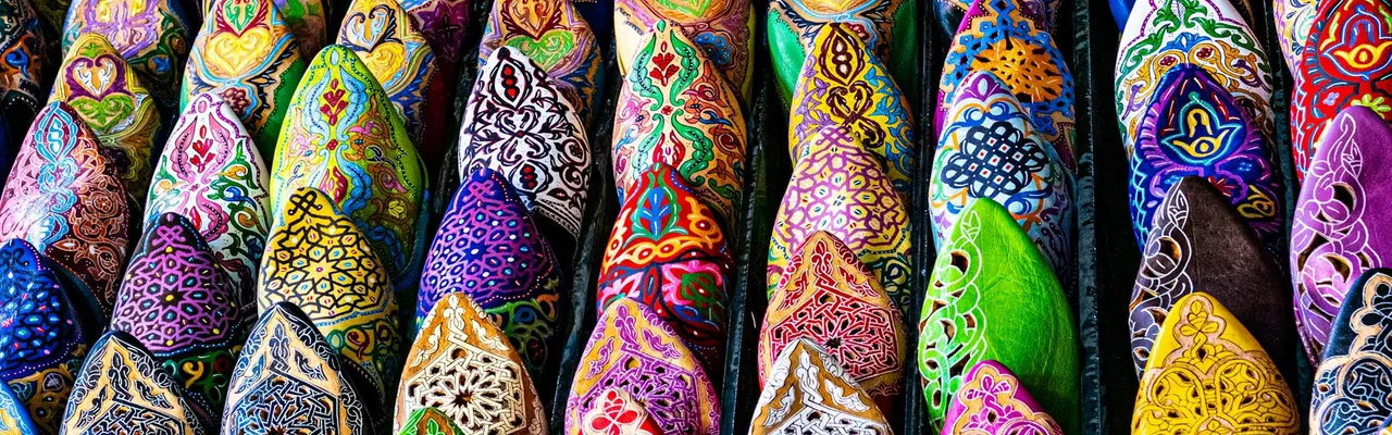 Vibrant handcrafted Moroccan slippers on display in Marrakesh, showcasing traditional artistry.